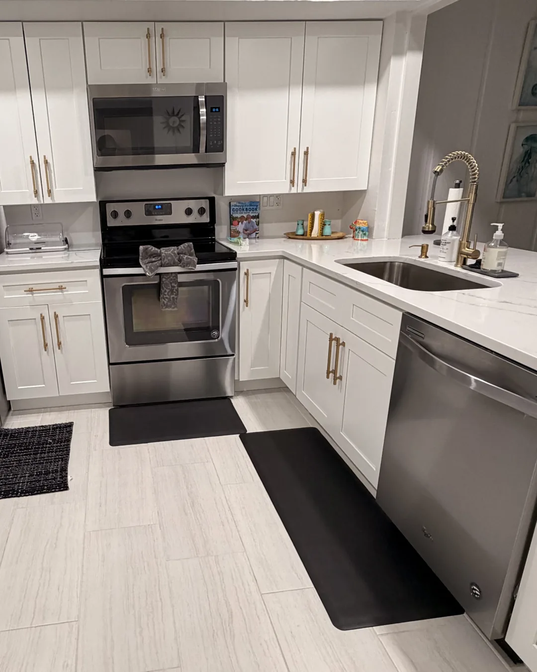 Fresh white kitchen with clean countertops and stainless-steel appliances