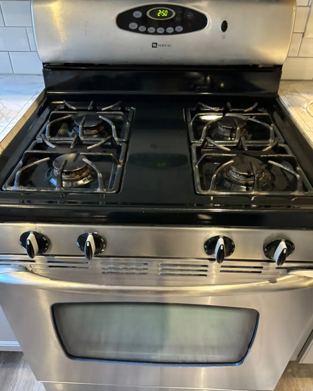 Detailed view of a freshly cleaned stainless-steel range and cooktop